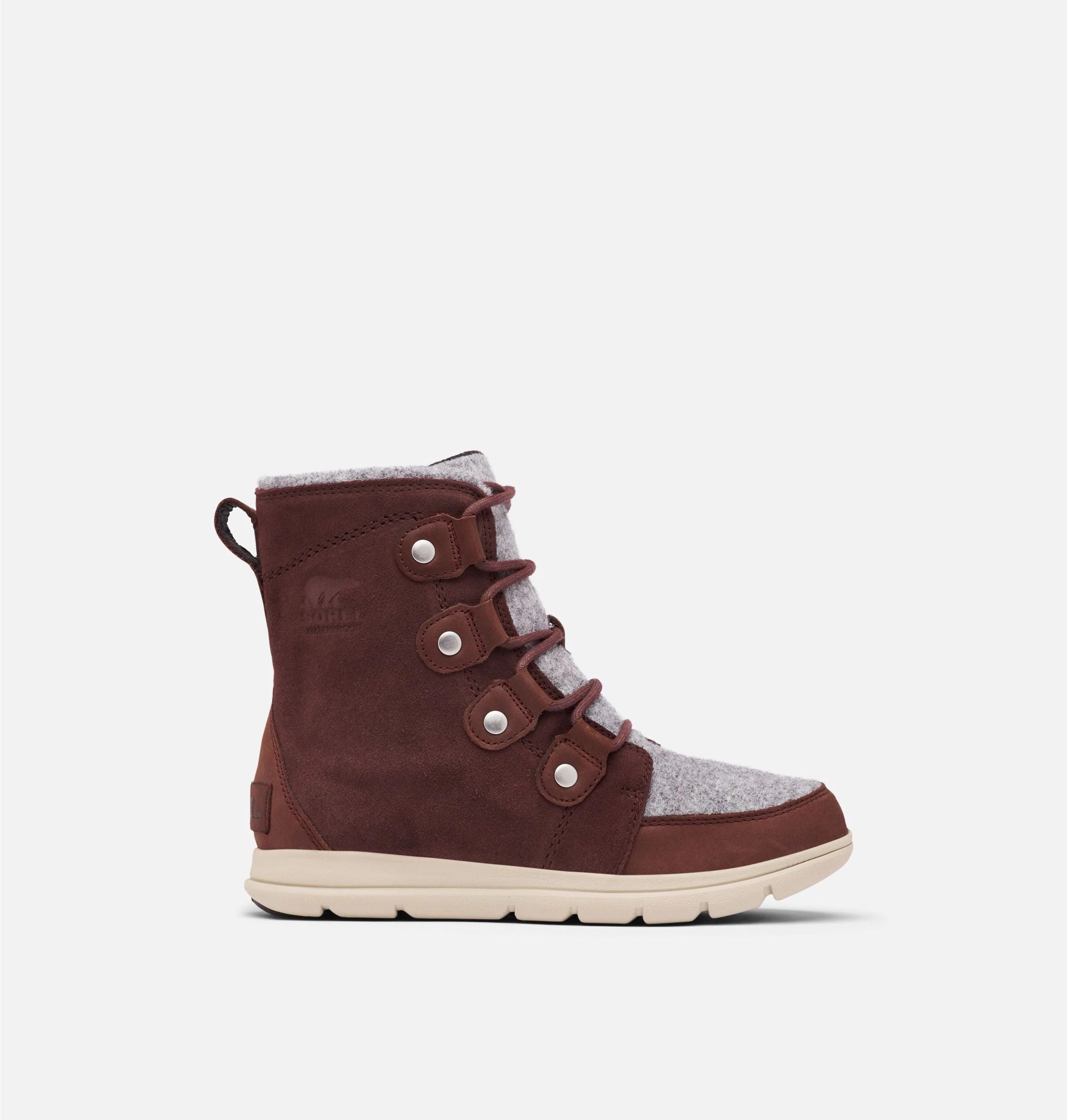 Side view of reddish brown suede winter ankle boot on white background. 