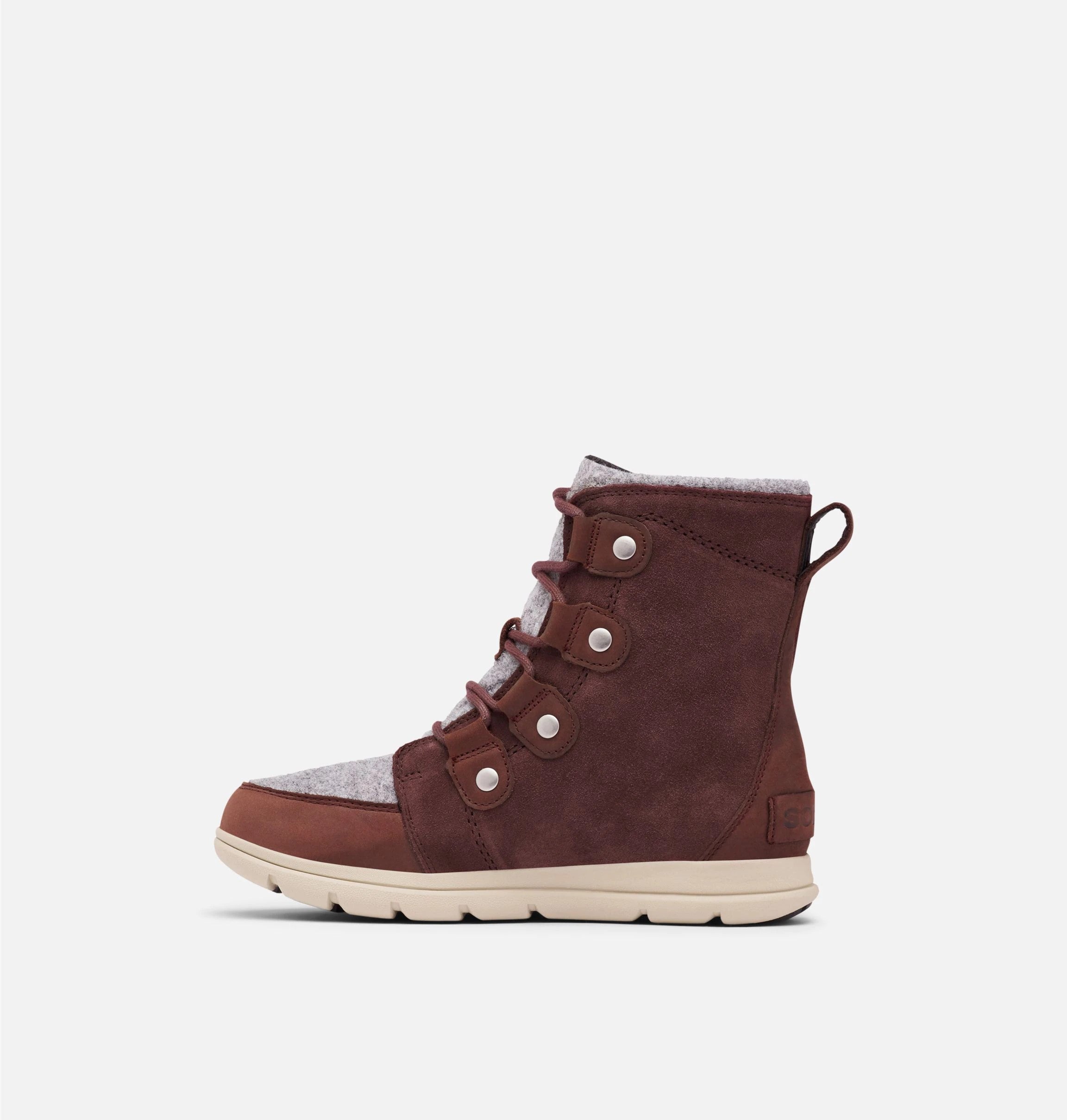 Left side view of reddish brown suede winter ankle boot on white background. 