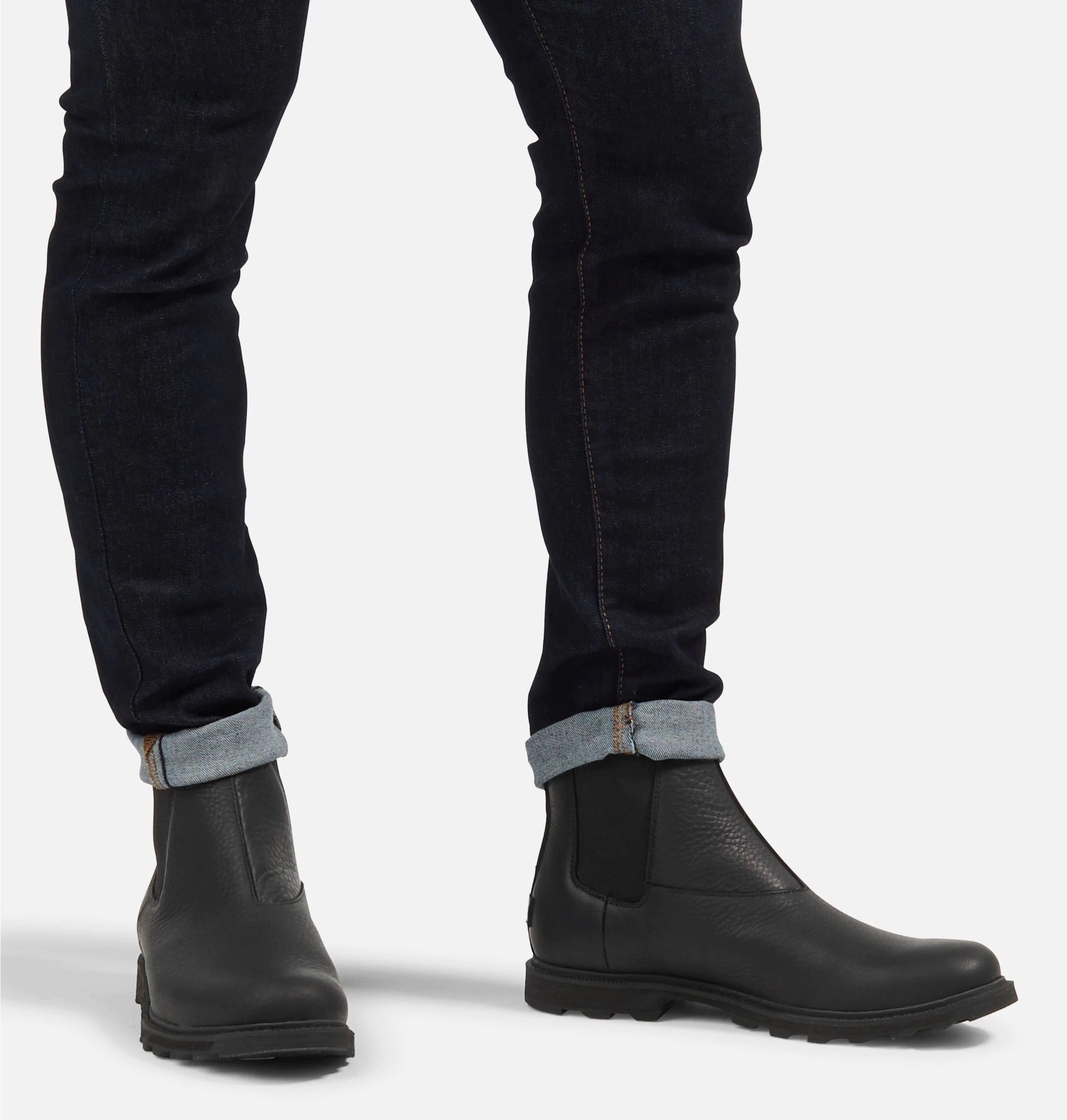 Front view of model wearing matt black ankle boot.  Picture shows how a user would look like wearing the boots. 