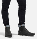 Load image into Gallery viewer, Front view of model wearing matt black ankle boot.  Picture shows how a user would look like wearing the boots. 
