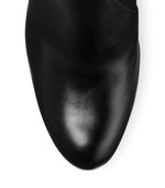 Load image into Gallery viewer, Close up top view of glossy black leather boot. 
