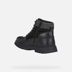 Load image into Gallery viewer, Rear left view of black leather winter ankle boot. Has a zipper.
