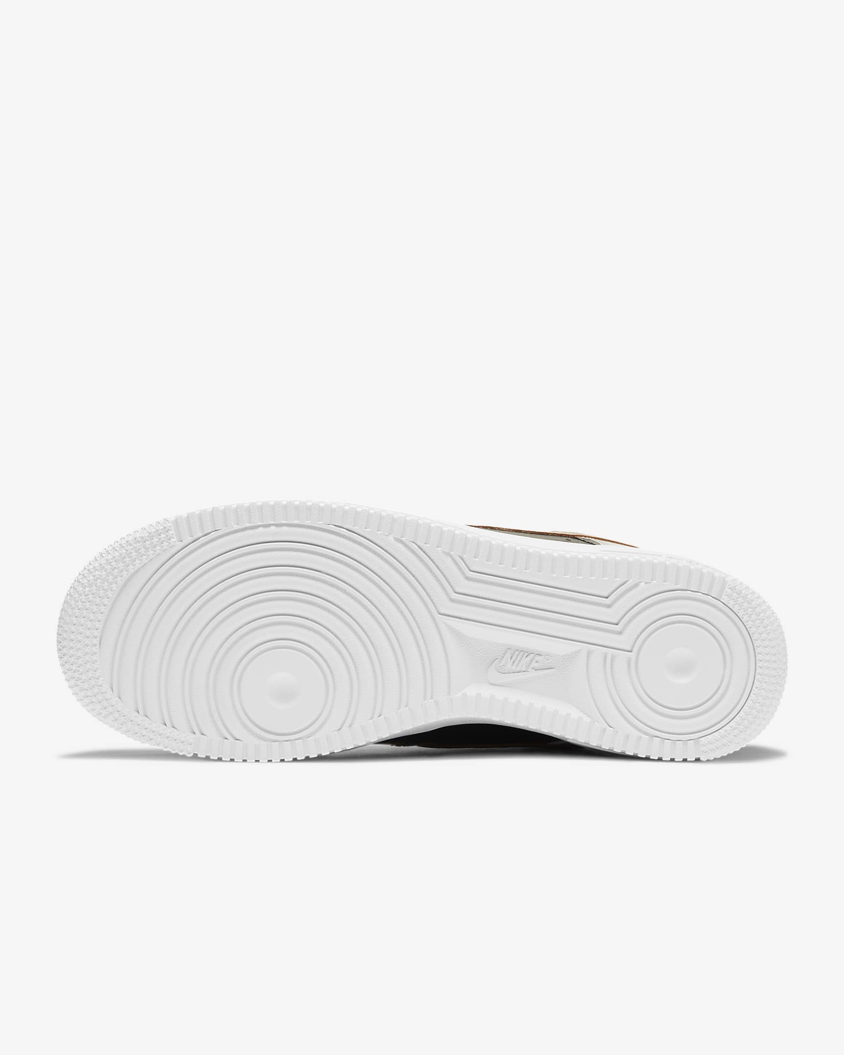 View of sole of Nike shoe. Is white and its threads are circular.