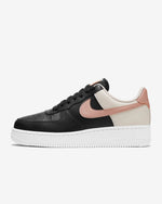 Load image into Gallery viewer, Side view of Nike running shoe. Has white midsole, pink Nike logo and colour is two tone black and beige leather.
