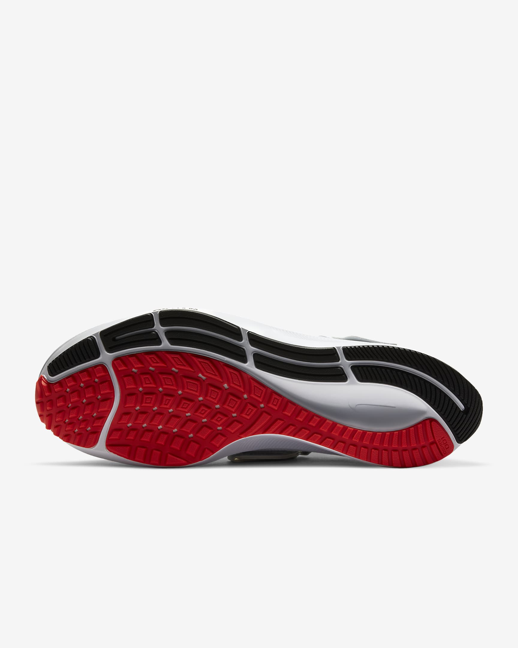 View of sole of black Nike running shoe. Threaded sole has red, white and black accents. 