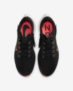 Load image into Gallery viewer, Top view of a pair of black Nike running shoes. Have black laces and red Nike logo.
