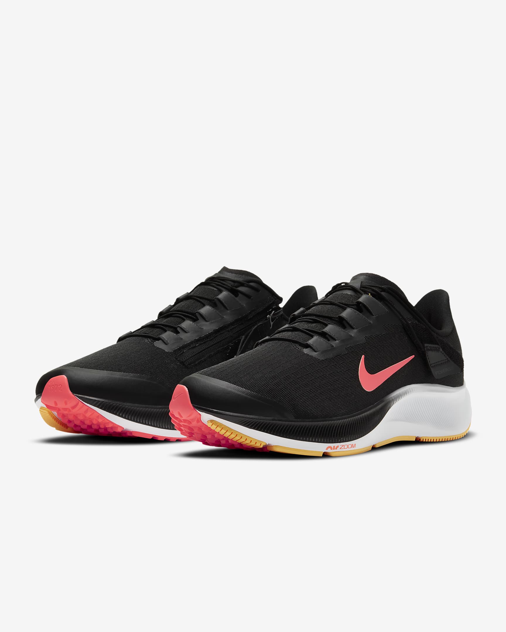 Front view of a pair of black Nike running shoe. Has red Nike logo, white midsole and black laces. 