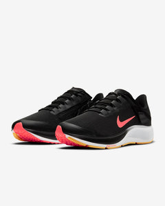 Front view of a pair of black Nike running shoe. Has red Nike logo, white midsole and black laces. 