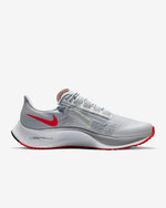 Load image into Gallery viewer, Side view of grey Nike running shoe. Has white midsole with inscription Air Zoom on the sides. Also has white laces and red Nike logo.
