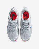 Load image into Gallery viewer, Top view of a pair of grey Nike running shoes. Have grey laces and blue Nike logo.
