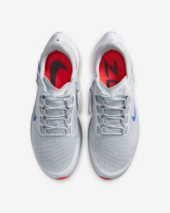 Top view of a pair of grey Nike running shoes. Have grey laces and blue Nike logo.