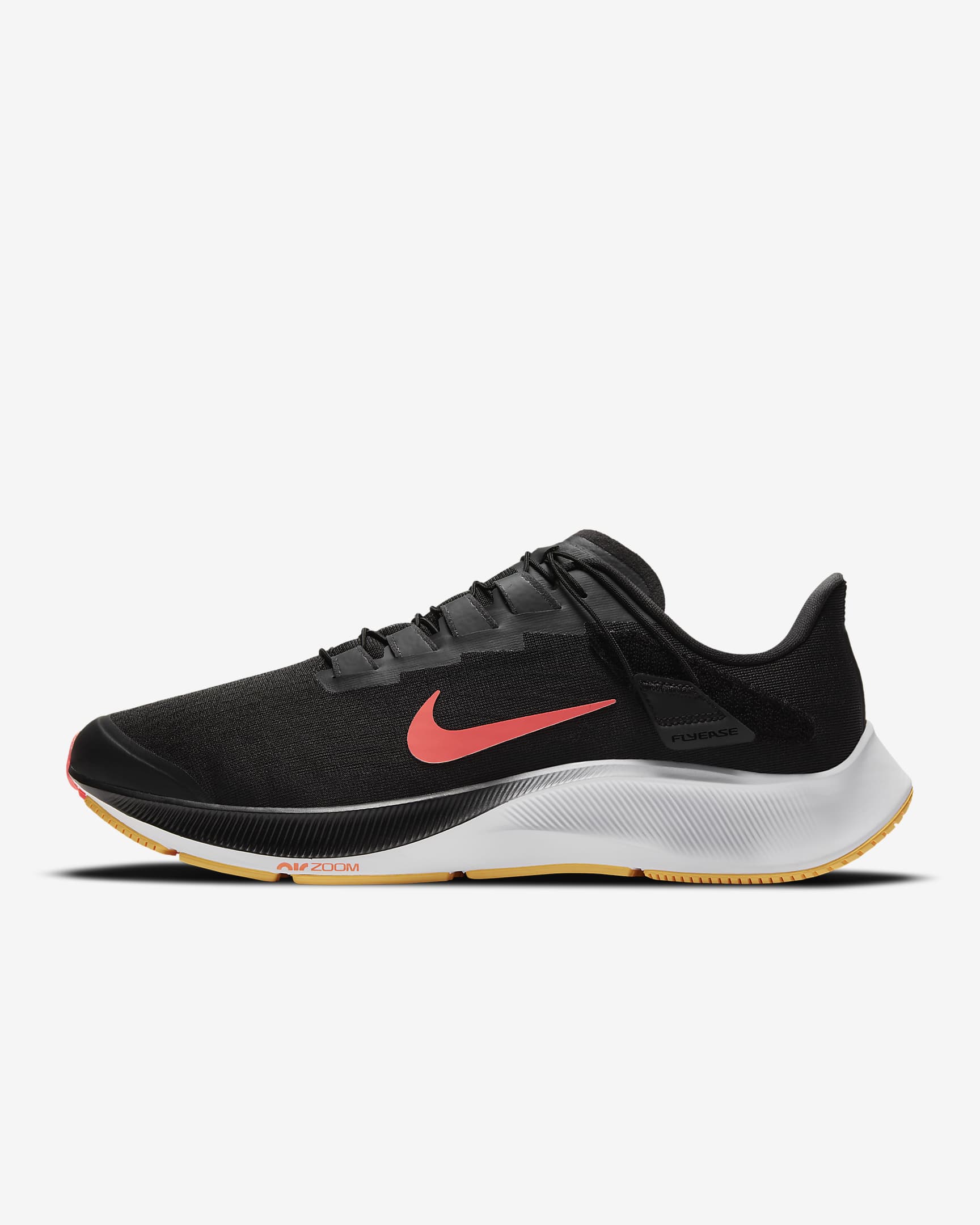 Side view of black Nike running shoe. Has black laces, red Nike logo and white midsole with Air Zoom inscription. 