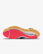 Load image into Gallery viewer, View of sole of Nike running shoe. Has threaded sole with yellow, orange and white accents. 
